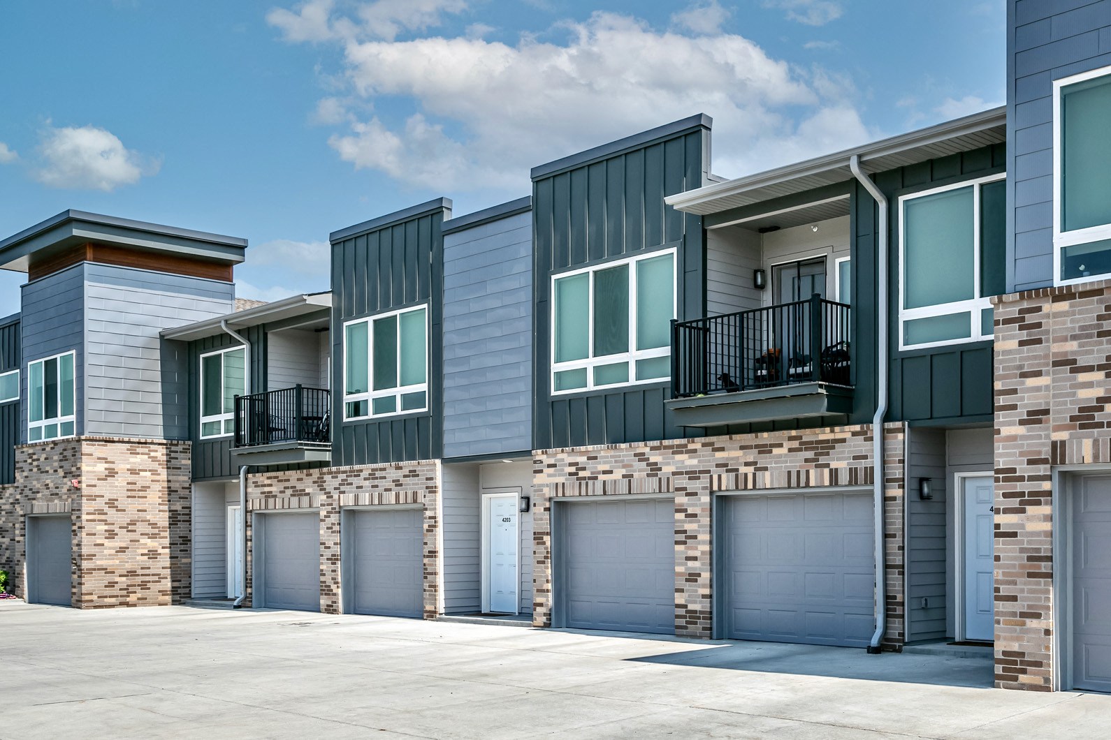 Property exterior with attached garages at AXIS apartments in Papillion, NE